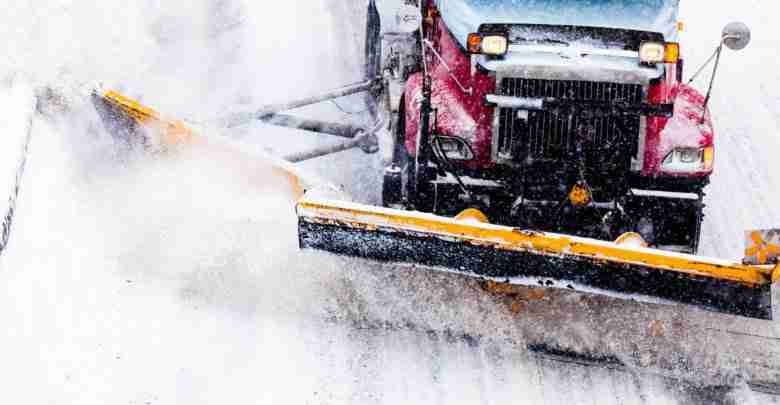 Snowplow Removing The Snow From The Highway During A Snowstorm