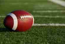 Collegiate Football on the Field with room for copy