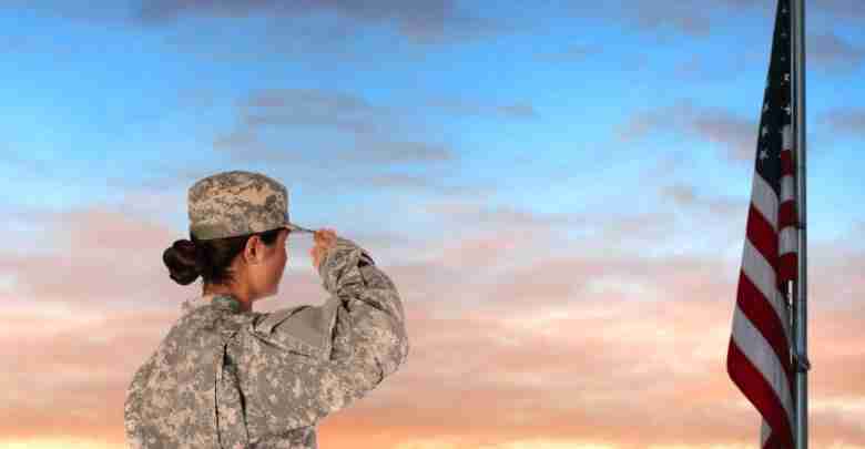Closeup of an American Female Soldier in combat uniform saluting