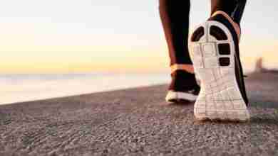 Runner man feet running on road closeup on shoe. Male fitness at